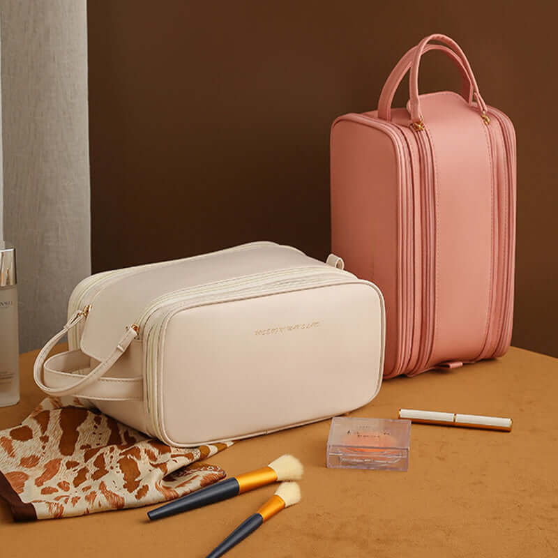 Double zipper cosmetic bags in pink and white, stylish and practical for makeup storage, placed on a decorative surface.