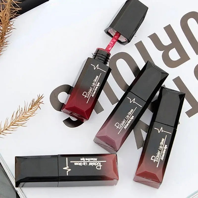 Collection of long-lasting matte lip glosses with a wand, featuring bold colors and sleek black packaging.