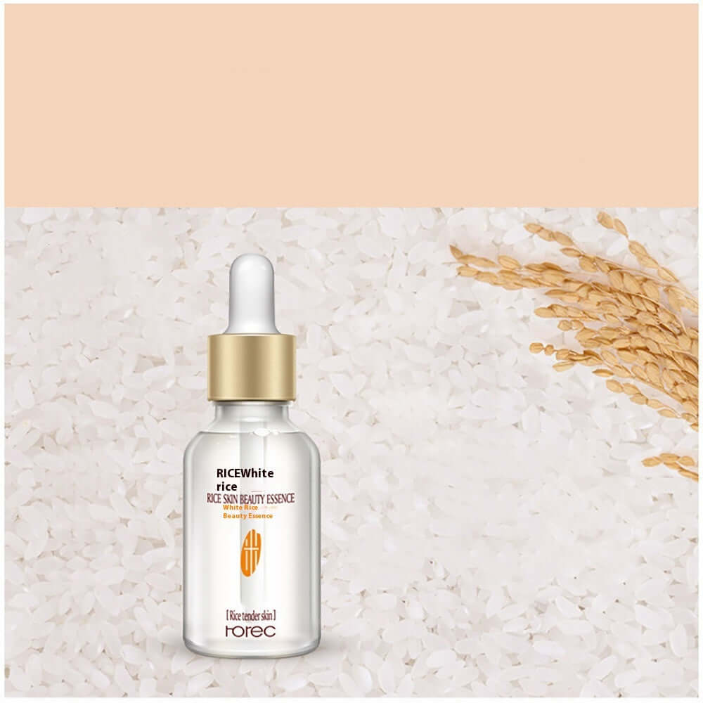 Rorec RICEWhite rice skin beauty essence serum in dropper bottle with rice grains background.