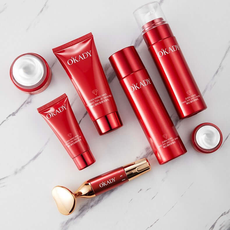 High-end skin care products set including cleansers, creams, and applicator on a marble surface.