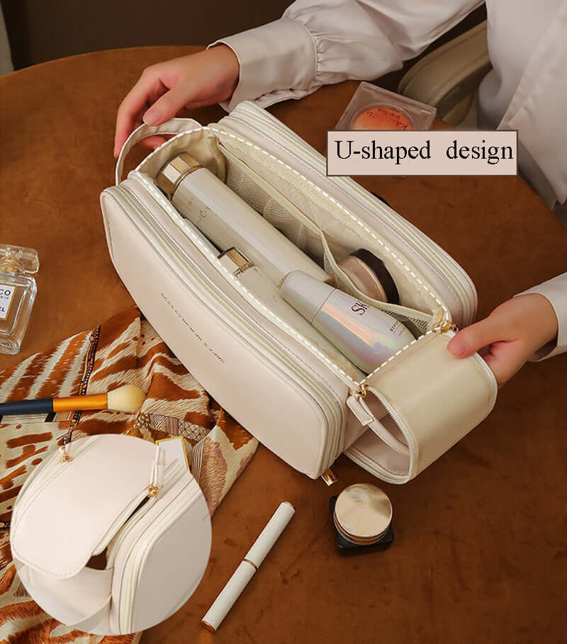 Double zipper cosmetic bag showcased with U-shaped design, elegantly displayed on a table with beauty products.