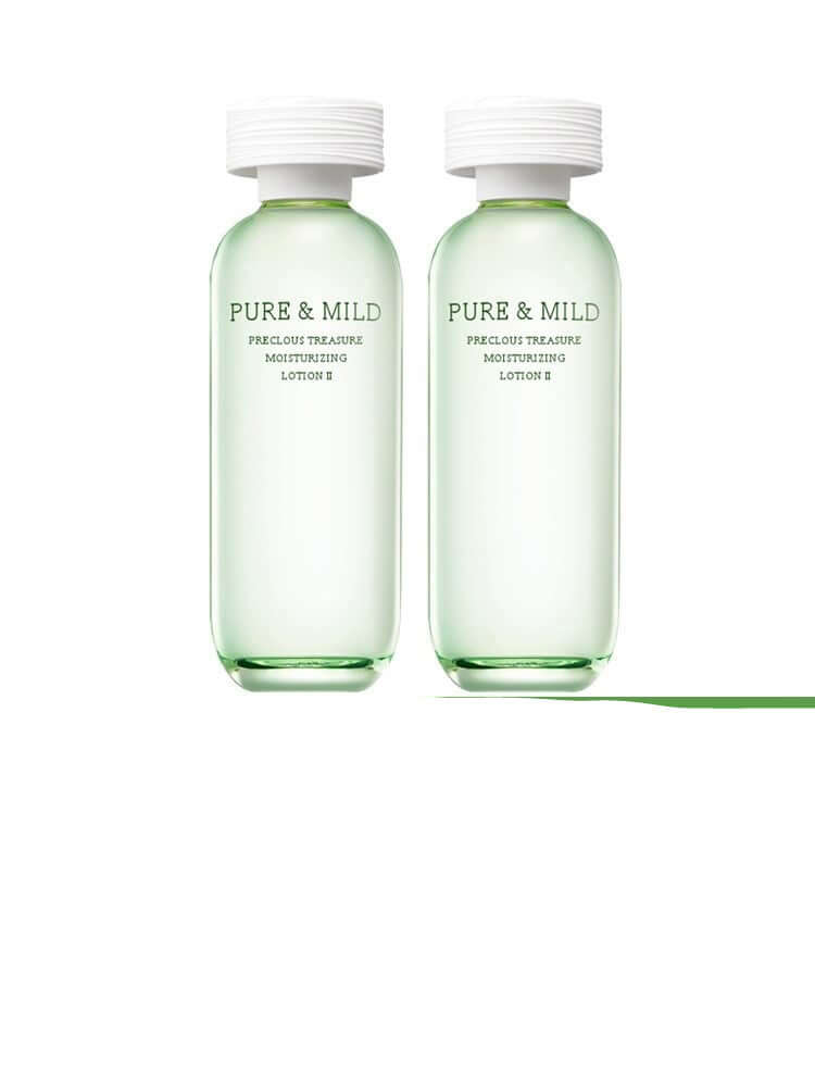 Pure & Mild moisturizing lotion set in green bottles for natural summer skincare.
