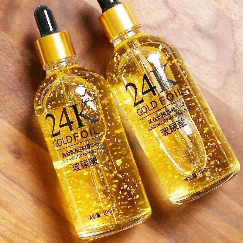 24K ginseng skin care essence bottles, 100g each, golden liquid with gold foil, suitable for neutral and mixed skin types.